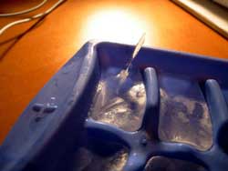 Ice tray with a spire of ice coming out of one cube
